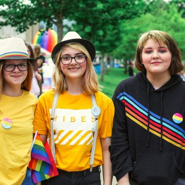 three Women Posing for a Group Photo