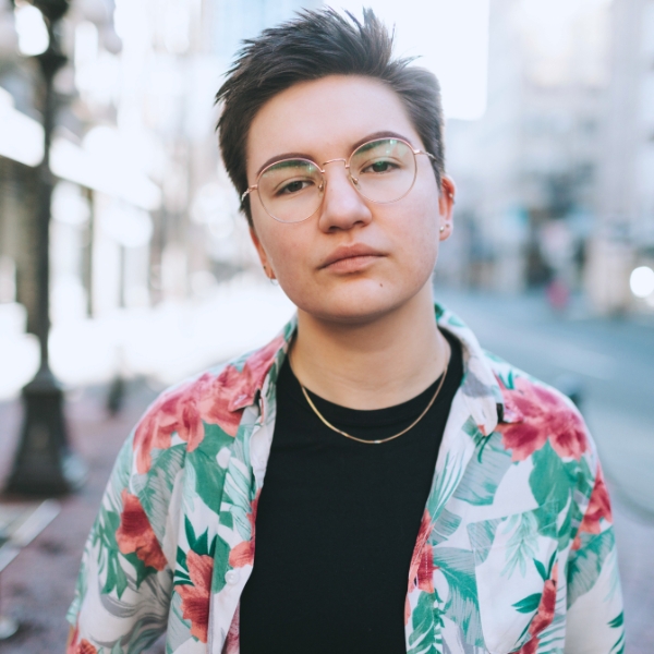 non-binary teenager wearing a tropical shirt